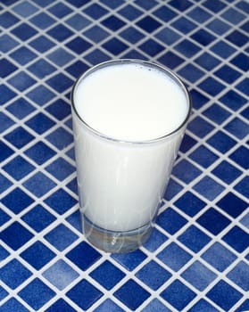 Glass of Milk towards blue mosaic
