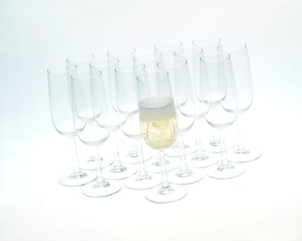 Glasses of champagne on white background