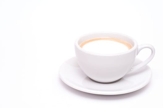 A cup of cappuccino against a white background