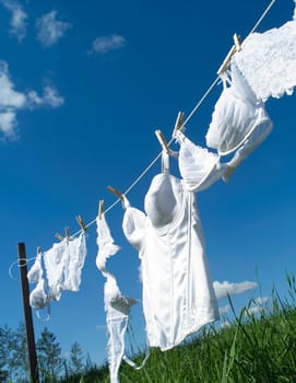 Female underwear on a clothesline towards blue sky