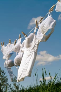 Female underwear on a clothesline towards blue sky