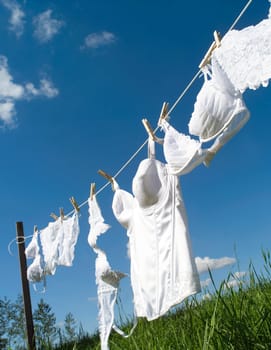 Female underwear on a clothesline towards blue sky
