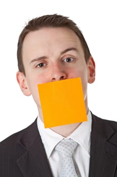 Businessman with postit note on mouth