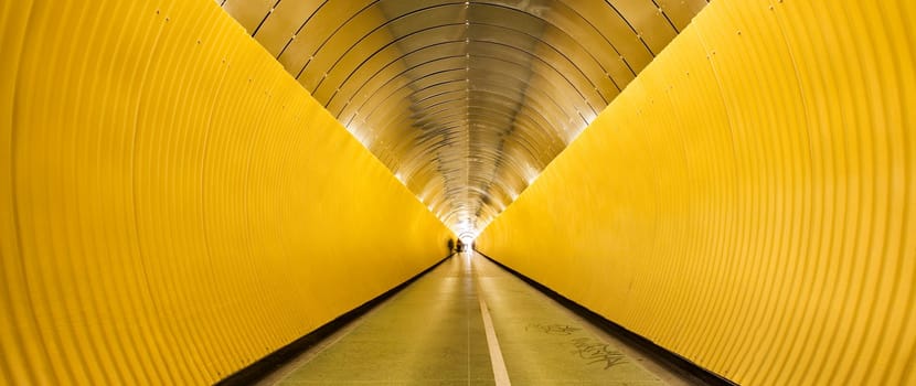 Yellow tunnel with people out of focus