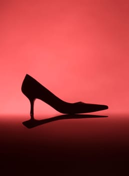 Female shoe on red background