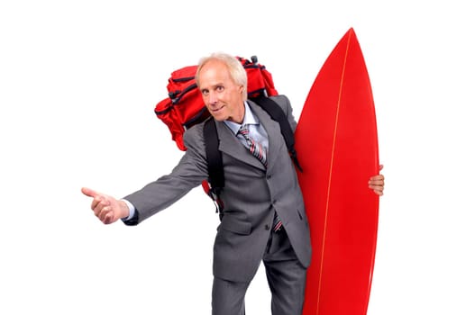 Mature businessman hitchhiking with backpack and surf board