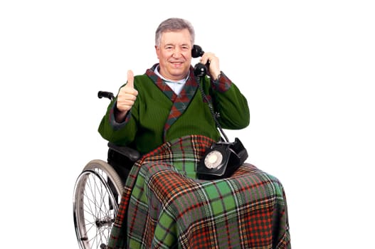 Happy elderly in a wheelchair receiving a call from his family