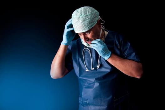 Stressed doctor in a dark background