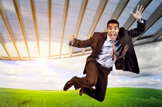 Happy businessman jumping outdoors