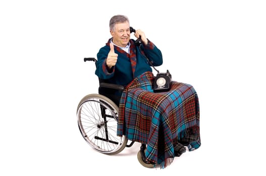 Happy elderly in a wheelchair receiving a call from his family