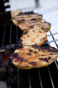 Close up of a Barbeque with potatoes