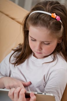 Little child (cute girl) learning with tablet at home