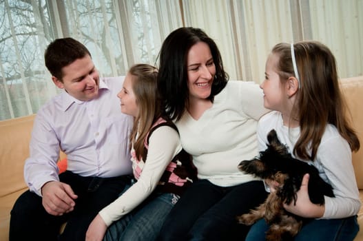 Happy family having great time together at home on sofa
