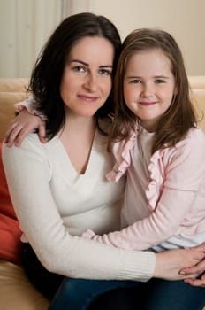 Portrait of child (cute girl) with mother - indoors at home