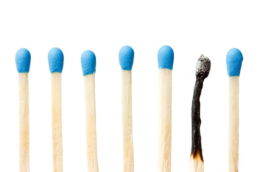 burnt match and a whole blue matches isolated on a white background