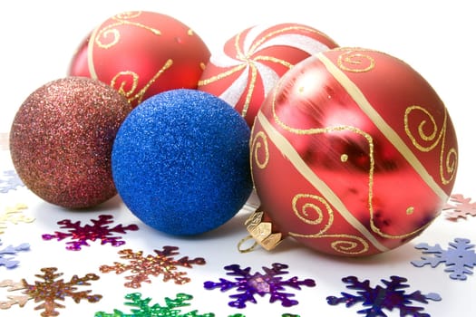 christmas decoration. baubles and color snowflakes over white.