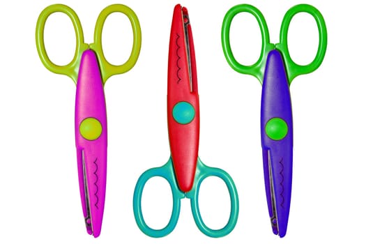 three color scissors isolated over a white background.