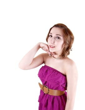 A young pretty girl in a pink strapless dress dress standing in the studio in a portrait shot for white background.