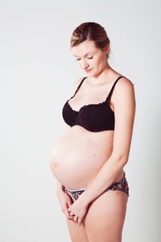 Portrait of a beautiful pregnant mother. Studio shot.