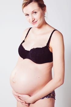 Portrait of a beautiful pregnant mother. Studio shot.