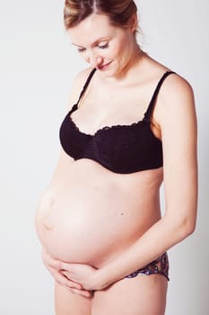 Portrait of a beautiful pregnant mother. Studio shot.