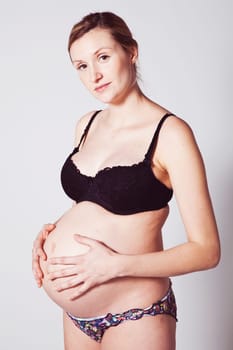 Portrait of a beautiful pregnant mother. Studio shot.