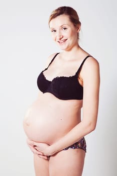Portrait of a beautiful pregnant mother. Studio shot.