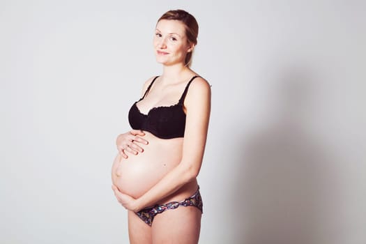 Portrait of a beautiful pregnant mother. Studio shot.