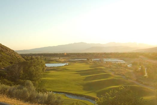 golf course view from above with bright sunlight from side