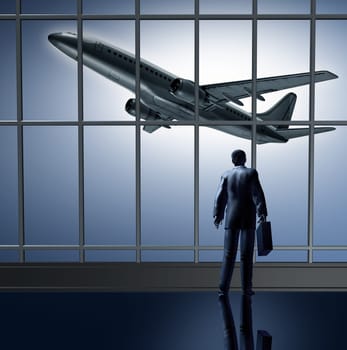Airport departure waiting at the terminal lounge represented by a businessman standing with a breifcase in front of large glass windows looking at an airplane taking off to an unknown destination.