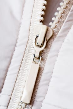 closeup of the zipper of a white jacket