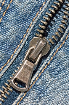 closeup of the zipper of a stylish blue jeans