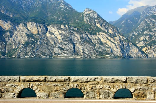 View over Lake Garda from the Gardesana Orientale (east shore road) to the galleries of the opposite Gardesana Occidentale (west shore road),Italy