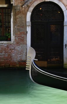 Bow of a gondola on a small canal in Venice,Italy