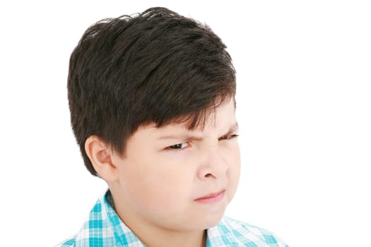 Close-up portrait of angry little boy isolated on white background