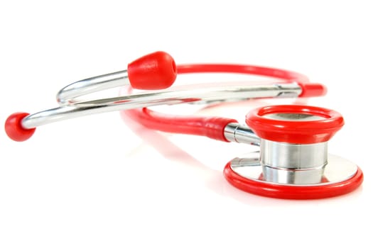 red medical stethoscope over a white background