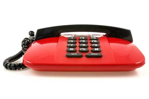 Red telephone set with reflection on white