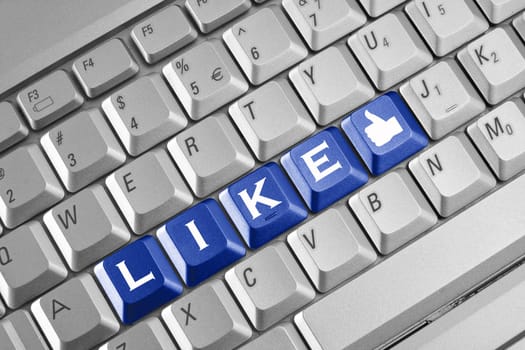 Social network concept . Keyboard with blue Like button.