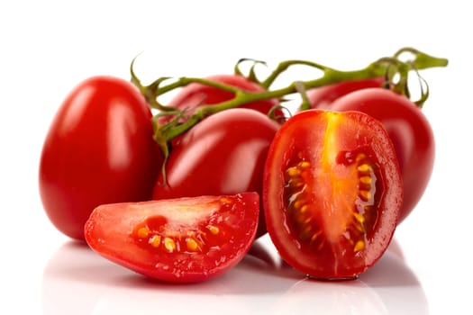 Fresh Roma tomatoes cut against white background