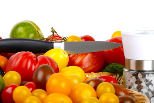 Numerous biotomets in a basket with knife and salt and pepper mill