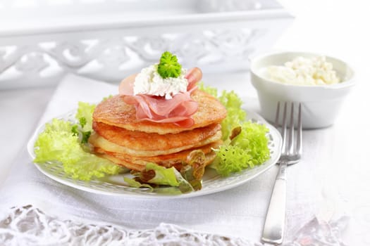 Delicious potato pancakes with curd cheese and herbs