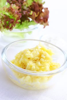 Mashed potatoes in bowl with salad