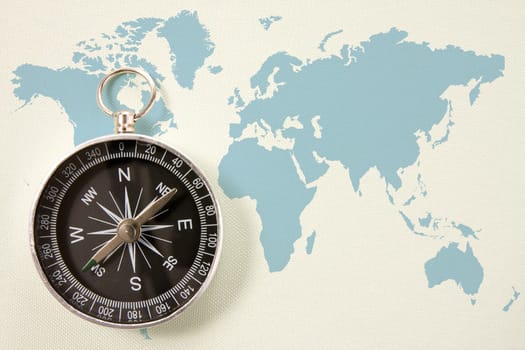 black compass on blue world map. concept for travel and tourism