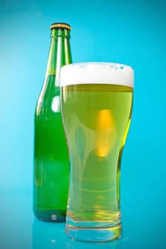 beer bottle and glass over a blue background