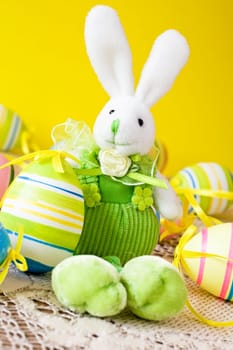 easter bunny with colorful decorative eggs around