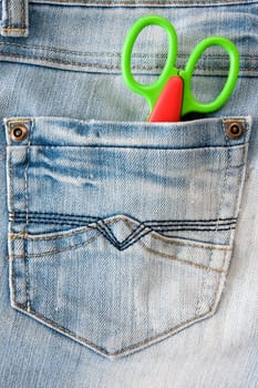 concept for  fashion and style. scissors in a jeans pocket.