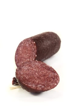 a sliced salami against a white background