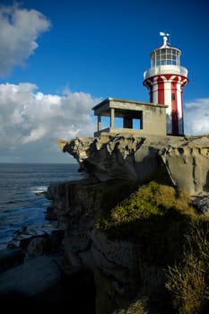 red and white lighthouse in Sydney, Watson Bay, ocean in background