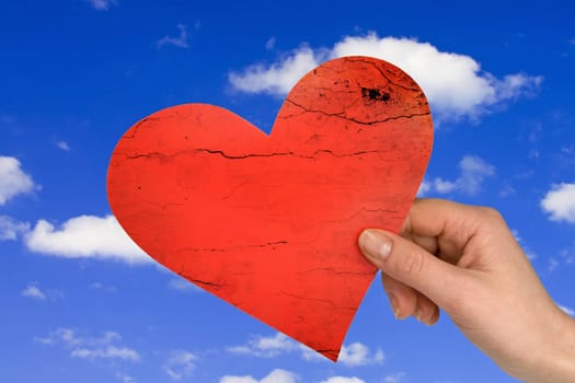 love concept. hand with heart on sky background