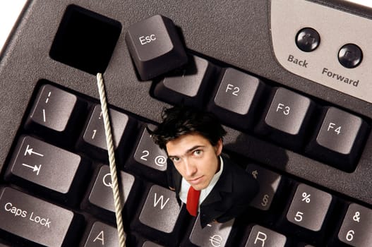 Businessman out of the Escape key in a computer keyboard